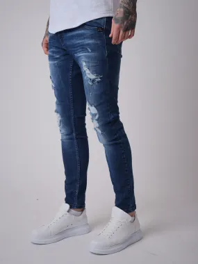 Jeans slim azules con efecto desgastado